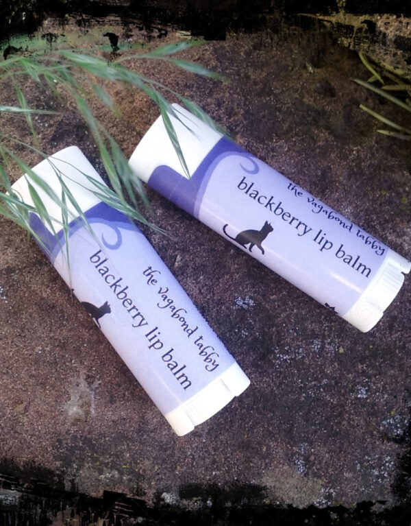 Two white lip balm tubes; the labels say blackberry.