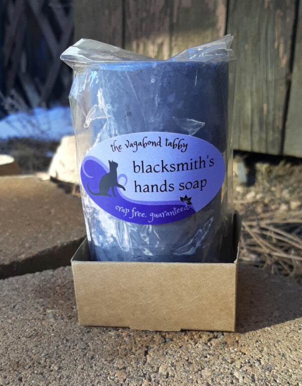 Three round grey bars of soap, packaged together.