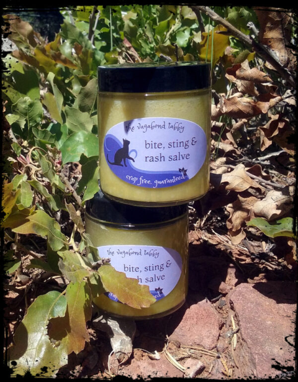 Two clear glass jars of pale yellow salve.