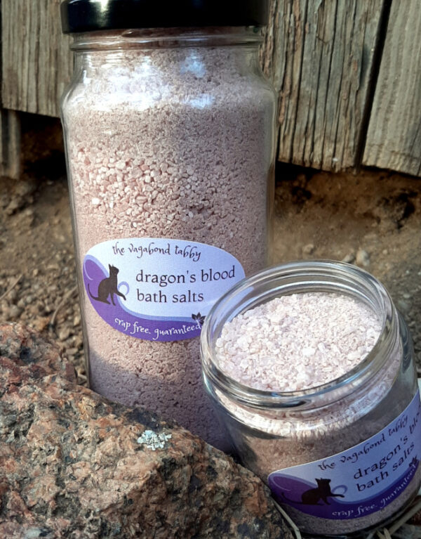 Two clear glass jars filled with reddish-brown bath salts.