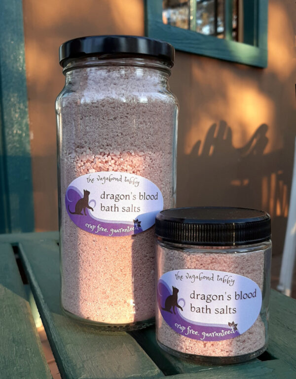 Two clear glass jars filled with reddish-brown bath salts.