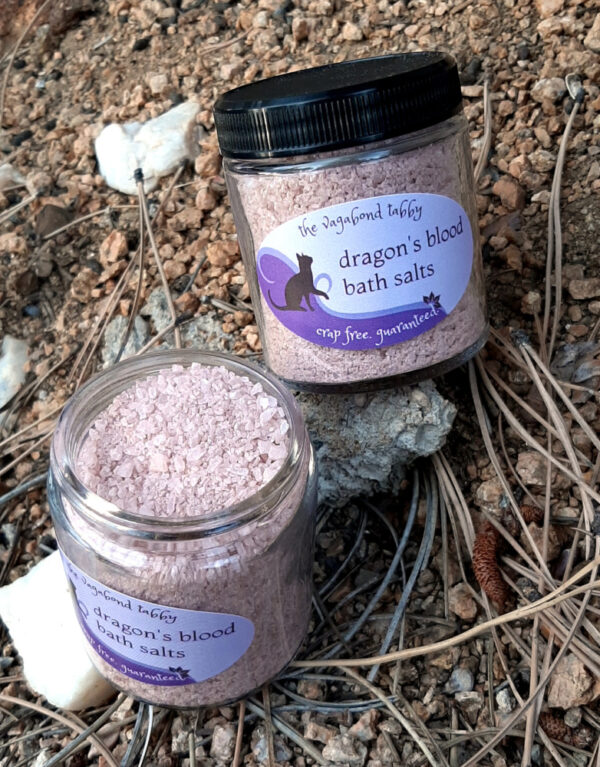 Two clear glass jars filled with reddish-brown bath salts.