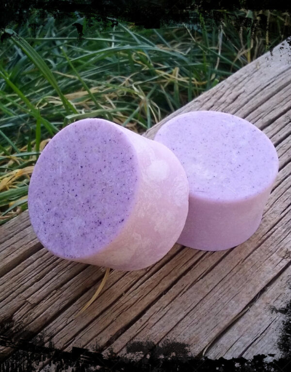Two bars of round pink soap.