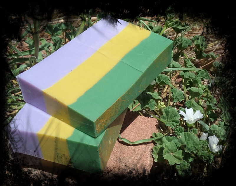 Two bars of soap, striped in green, yellow, and purple.