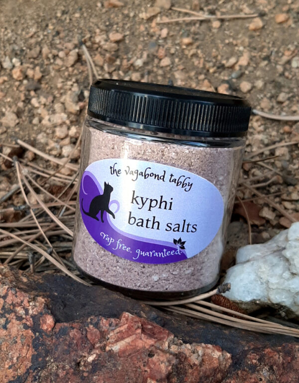 A clear glass jar filled with brown bath salts.