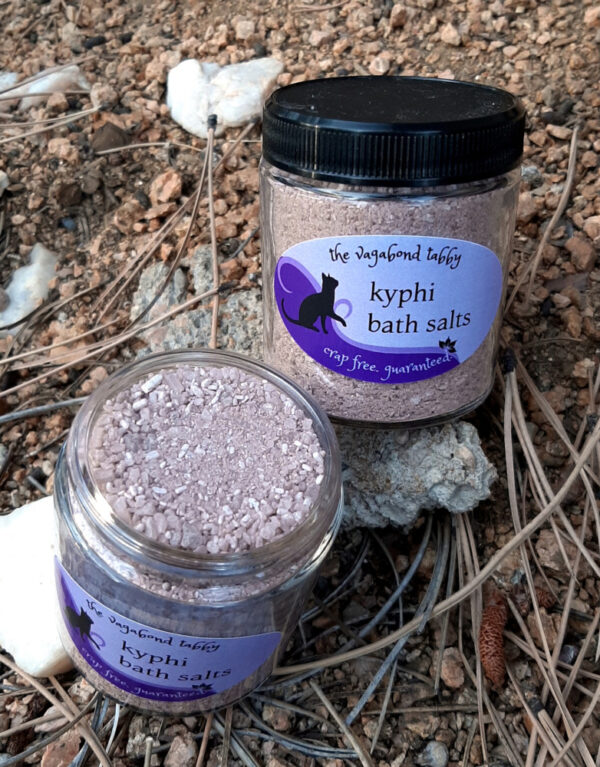 Two clear glass jars, each filled with brown bath salts.