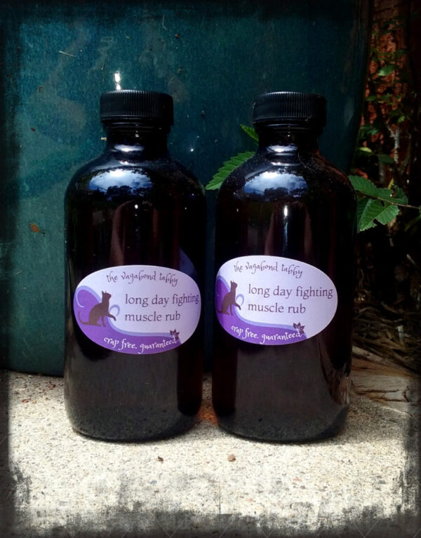 Two tall amber glass bottles; the labels say long day fighting muscle rub.