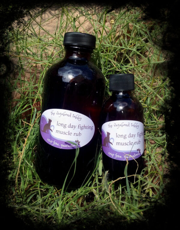 Two amber glass bottles, one much larger than the other; the labels say long day fighting muscle rub.