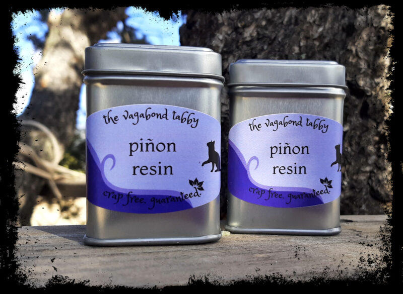 Two metal tins; the labels say pinyon resin.