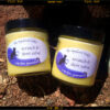 Two glass jars of golden-yellow salve.