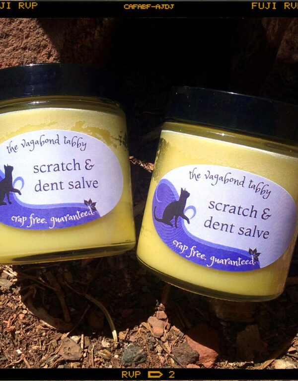 Two glass jars of golden-yellow salve.