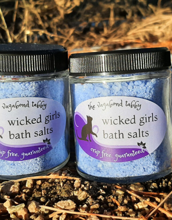 Two glass jars filled with blue bath salts.