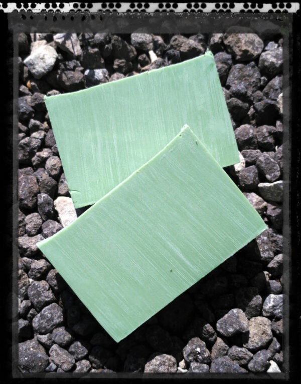 Two bars of yellowish-green soap.