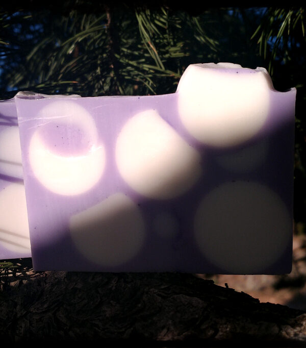 A bar of soap, purple with white spheres.