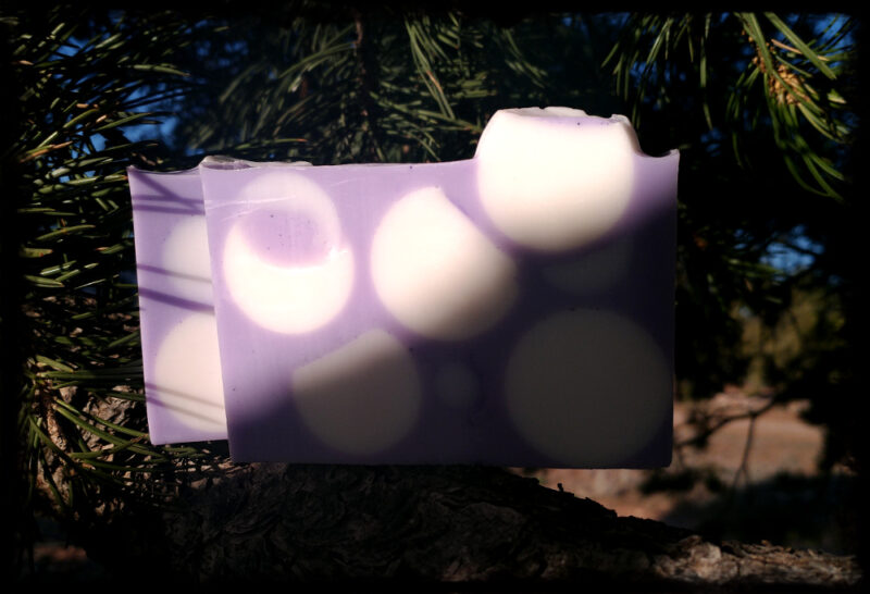 A bar of soap, purple with white spheres.