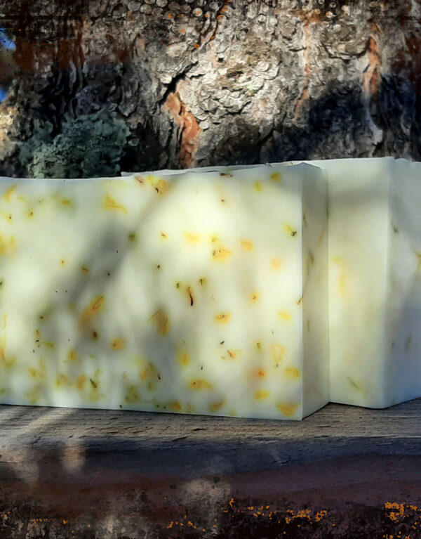 Two bars of pale yellow soap with tiny yellow flower petals.