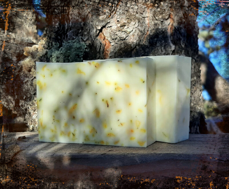 Two bars of pale yellow soap with tiny yellow flower petals.