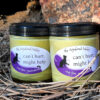 Two clear glass jars of pale yellow salve.