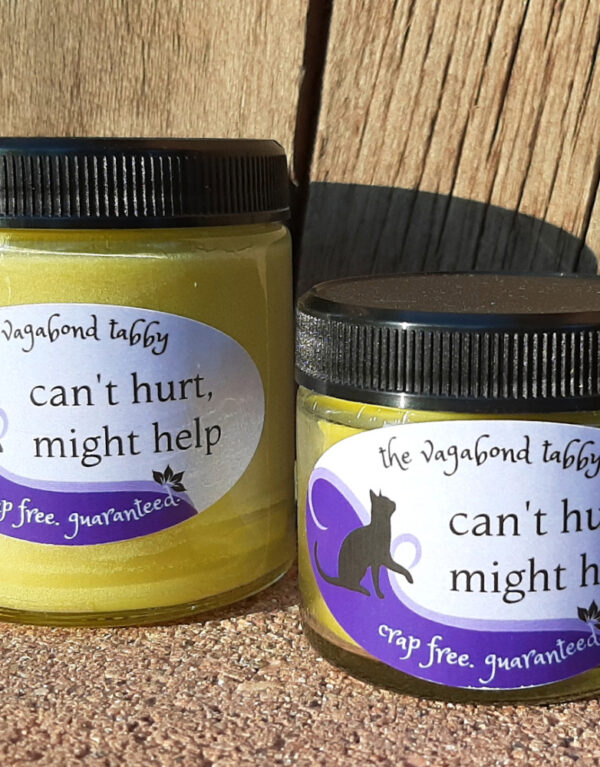 Two clear glass jars of pale yellow salve, one bigger than the other.