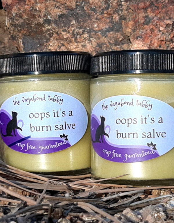 Two jars of pale yellow salve.