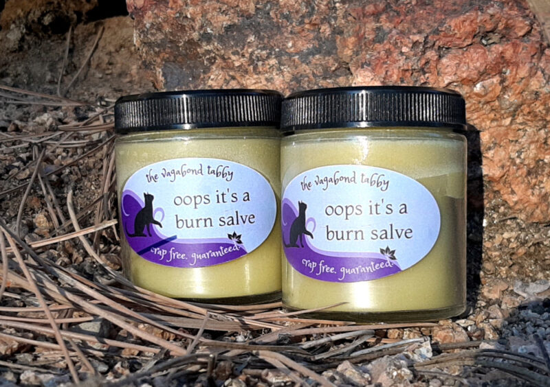 Two jars of pale yellow salve.