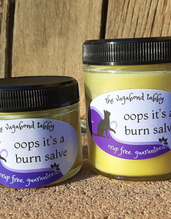 Two jars of pale yellow salve, one bigger than the other.