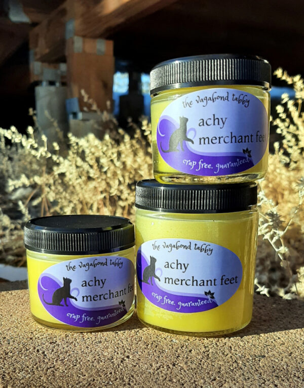 Three jars of pale yellow salve; one is larger than the other two.