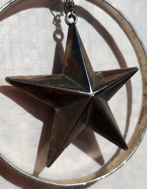 A closer view of the star, which is firmly three-dimensional, thicker at the center, tapering to the points.