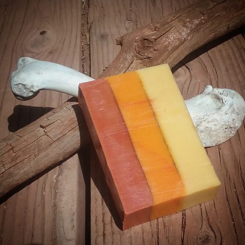 A bar of soap, layered in yellow, orange, and red.