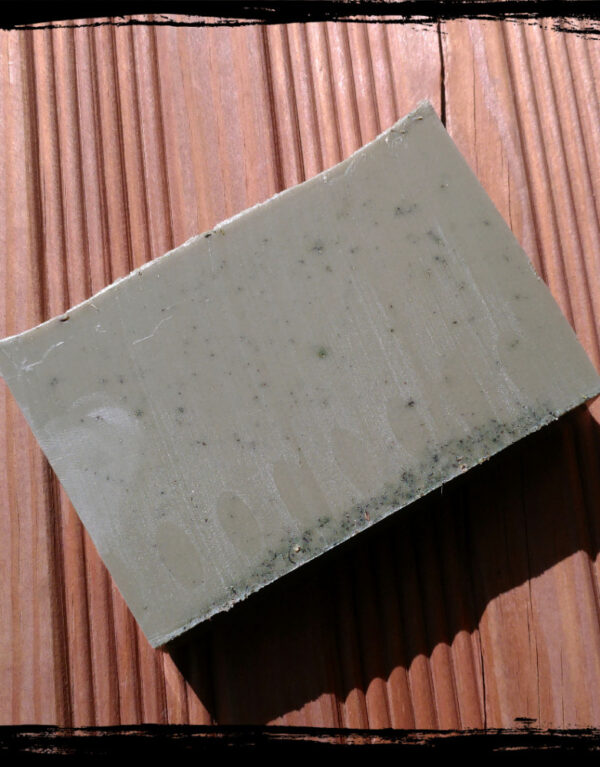 A bar of deep forest green soap.