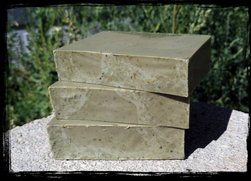 Three bars of deep forest green soap.