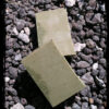 Two bars of deep forest green soap.