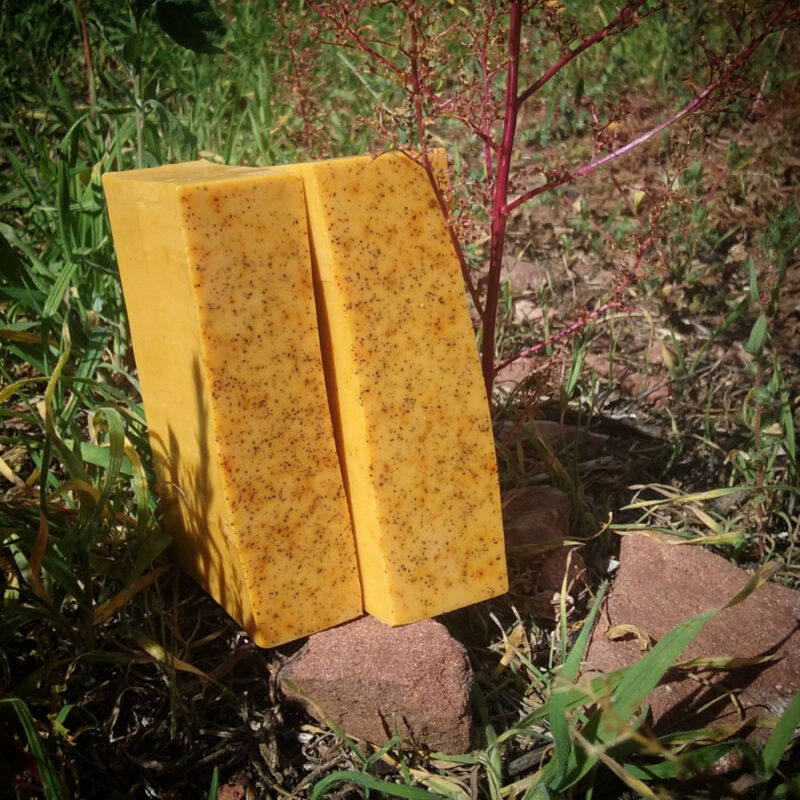 Two bars of lightly speckled orange soap.