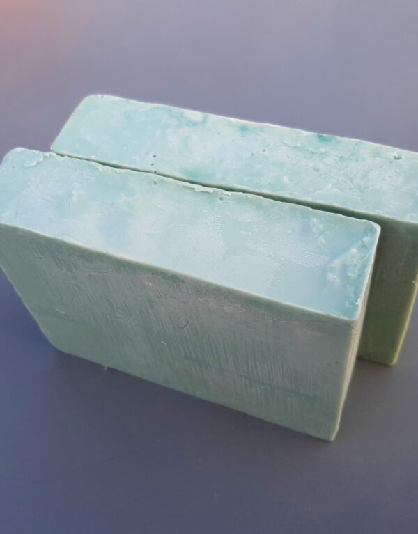 Two bars of softly green soap.