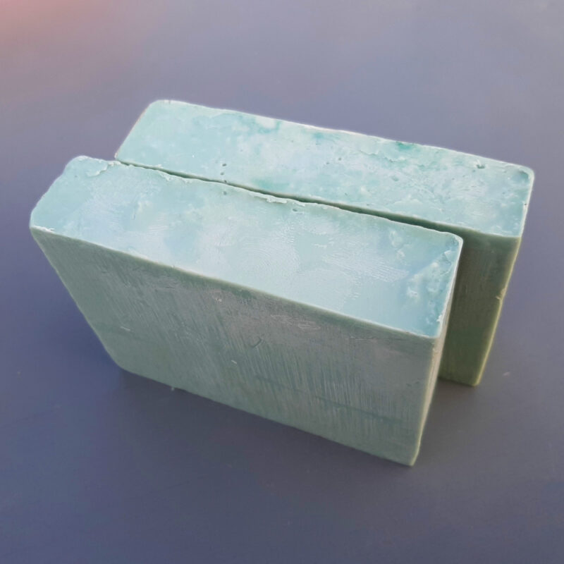 Two bars of softly green soap.